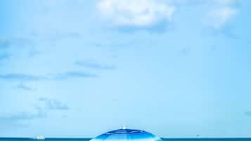 A beach scene with a blue umbrella.