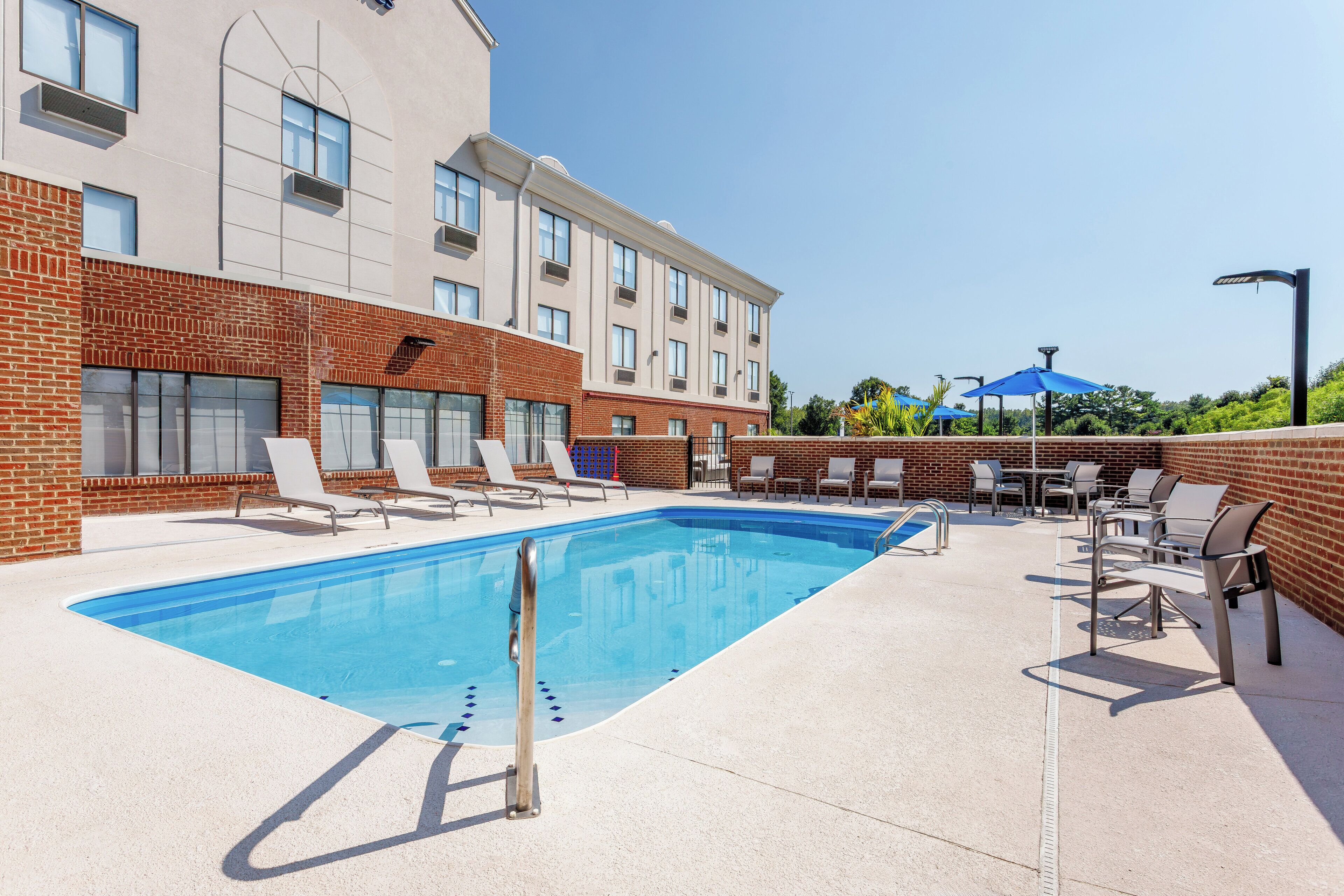 Seasonal outdoor pool, open 6:00 AM to 11:00 PM, pool umbrellas