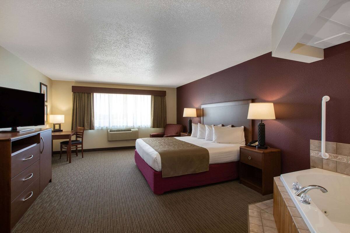 superior suite, 1 king bed, non smoking | in-room safe, desk, laptop workspace, soundproofing