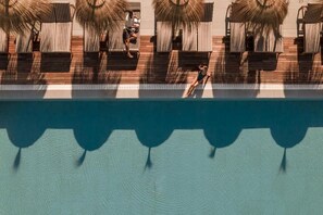 Outdoor pool, open 10 AM to 6 PM, pool umbrellas, pool loungers