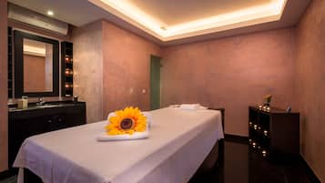 Relax in a serene space with a neatly made bed, a stylish vanity, and a wall-mounted air conditioning unit.