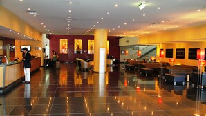 A spacious lobby with a reception desk, seating area, and a staircase leading to upper floors. - Vila Gale Opera Hotel (Lisbon)