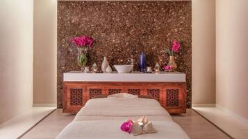 Relax in a serene space with a large bed, a wooden cabinet, and a beautiful orchid.