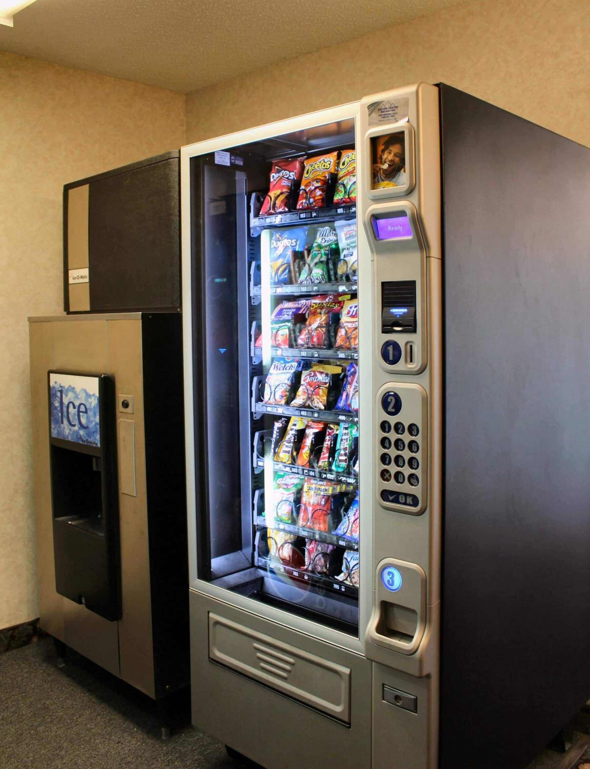 A vending machine with a variety of snacks and a separate ice dispenser.