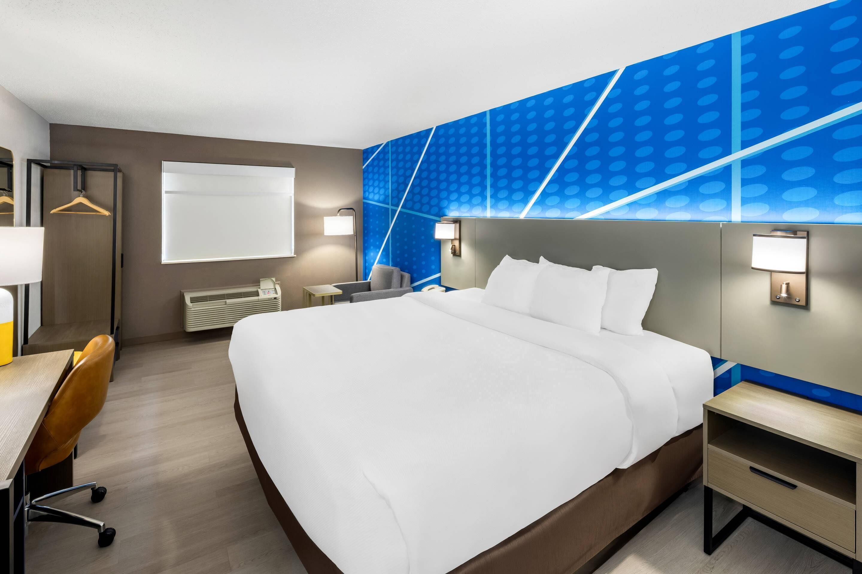 Premium bedding, desk, laptop workspace, blackout drapes