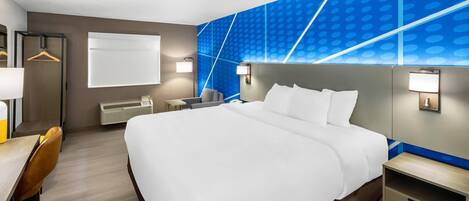 Premium bedding, desk, laptop workspace, blackout drapes