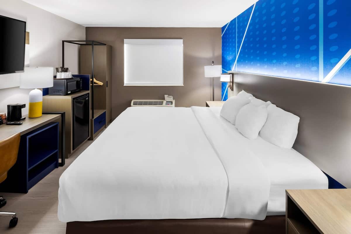 Premium bedding, desk, laptop workspace, blackout drapes