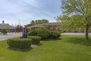 Welcome to our hotel, featuring a well-manicured lawn and a convenient entrance.