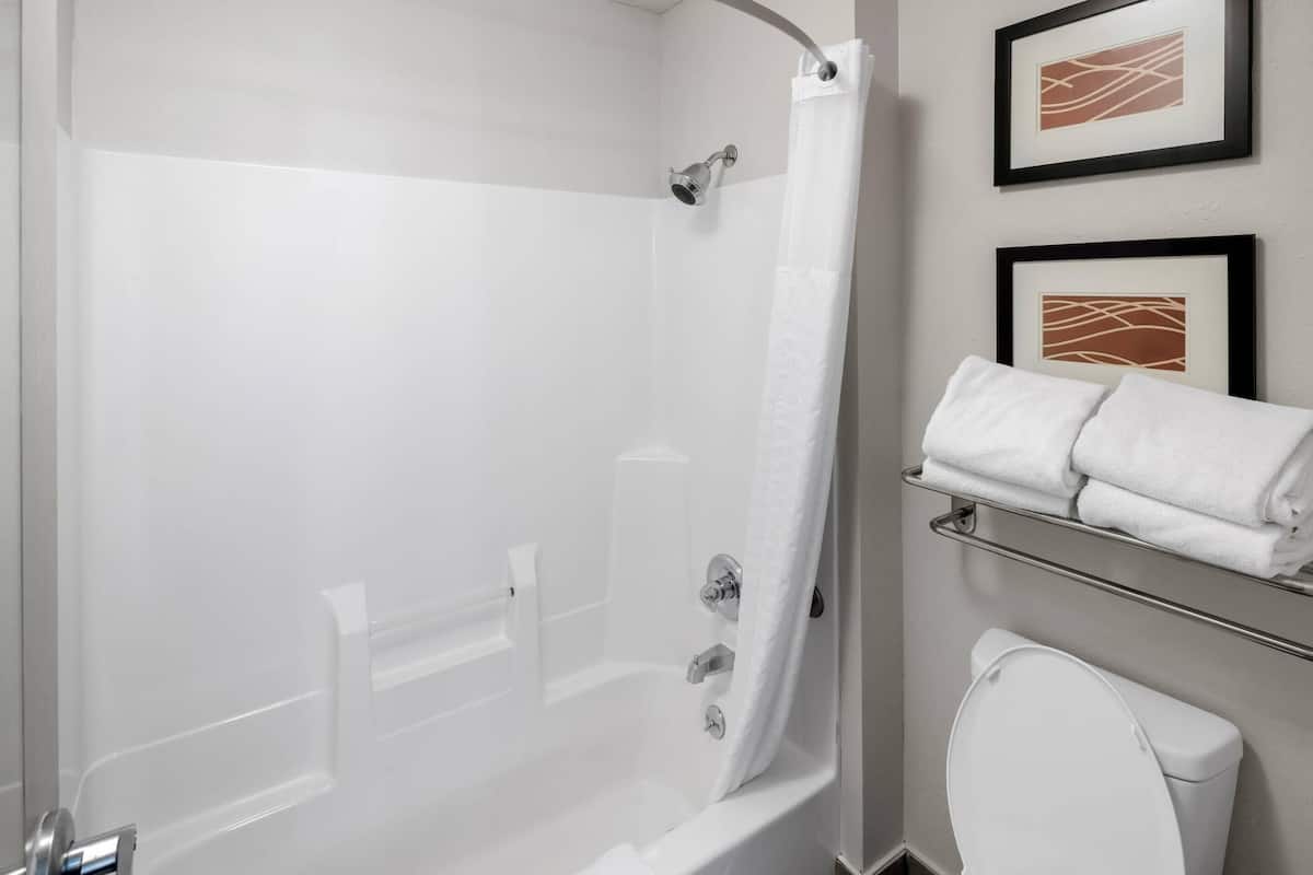Premium bedding, desk, laptop workspace, blackout drapes