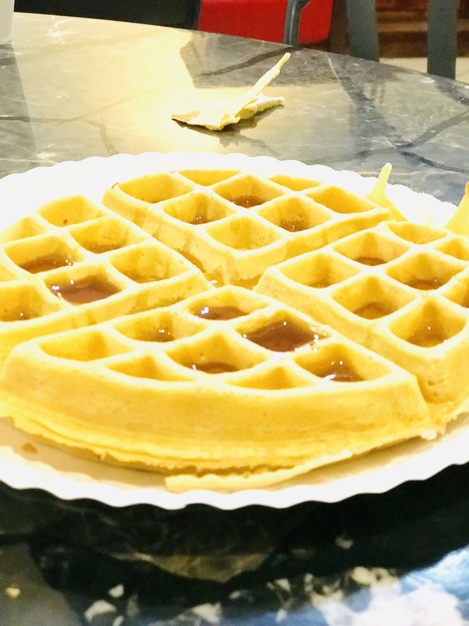 Ein Waffel auf einem Teller mit Sirup.