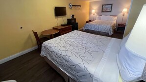 A hotel room with two beds, a desk, a chair, a television, and a lamp. - Motel 6 San Francisco, CA - Fisherman's Wharf (San Francisco)