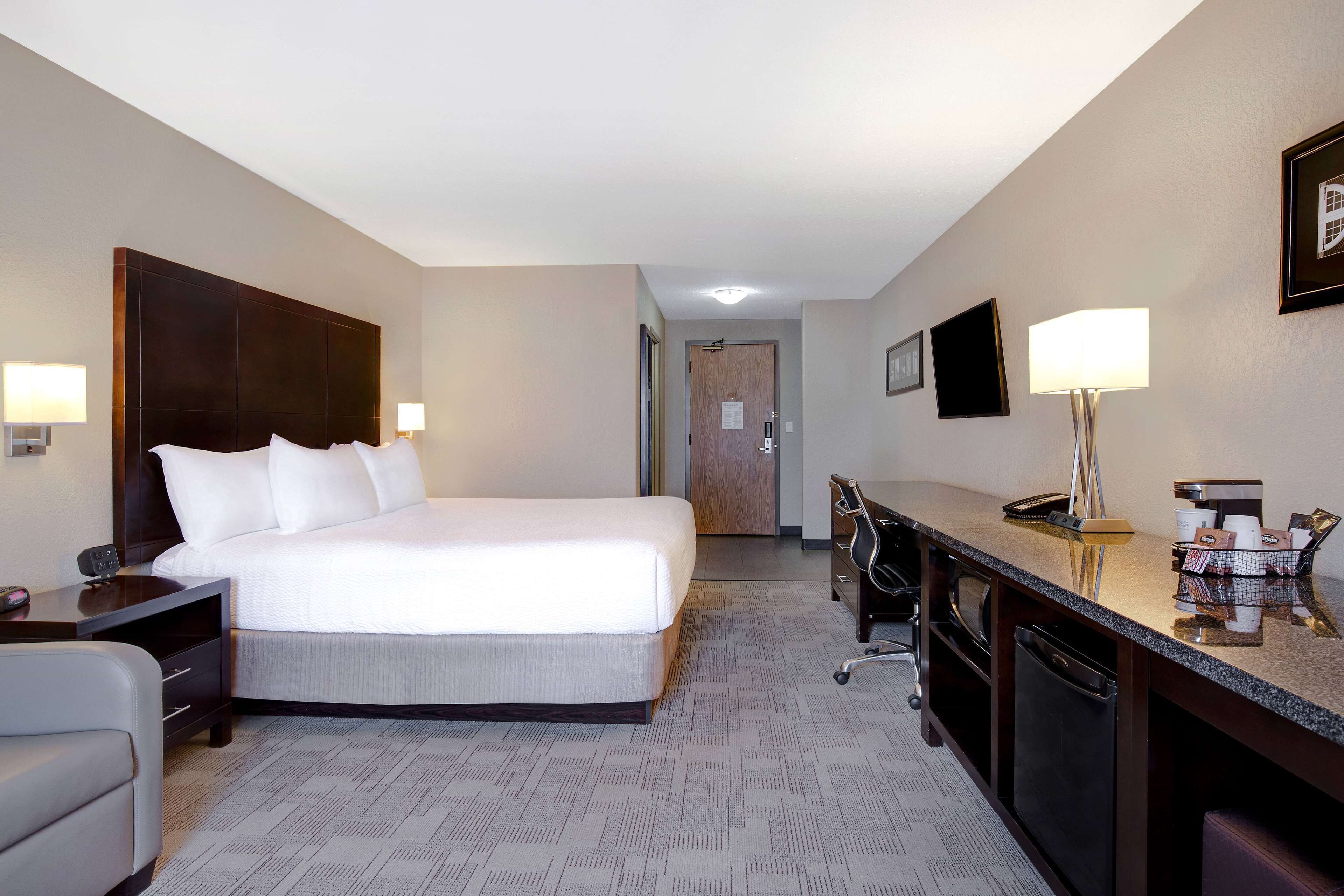 classic 1 king bed room with sofa bed | premium bedding, desk, blackout curtains, iron/ironing board