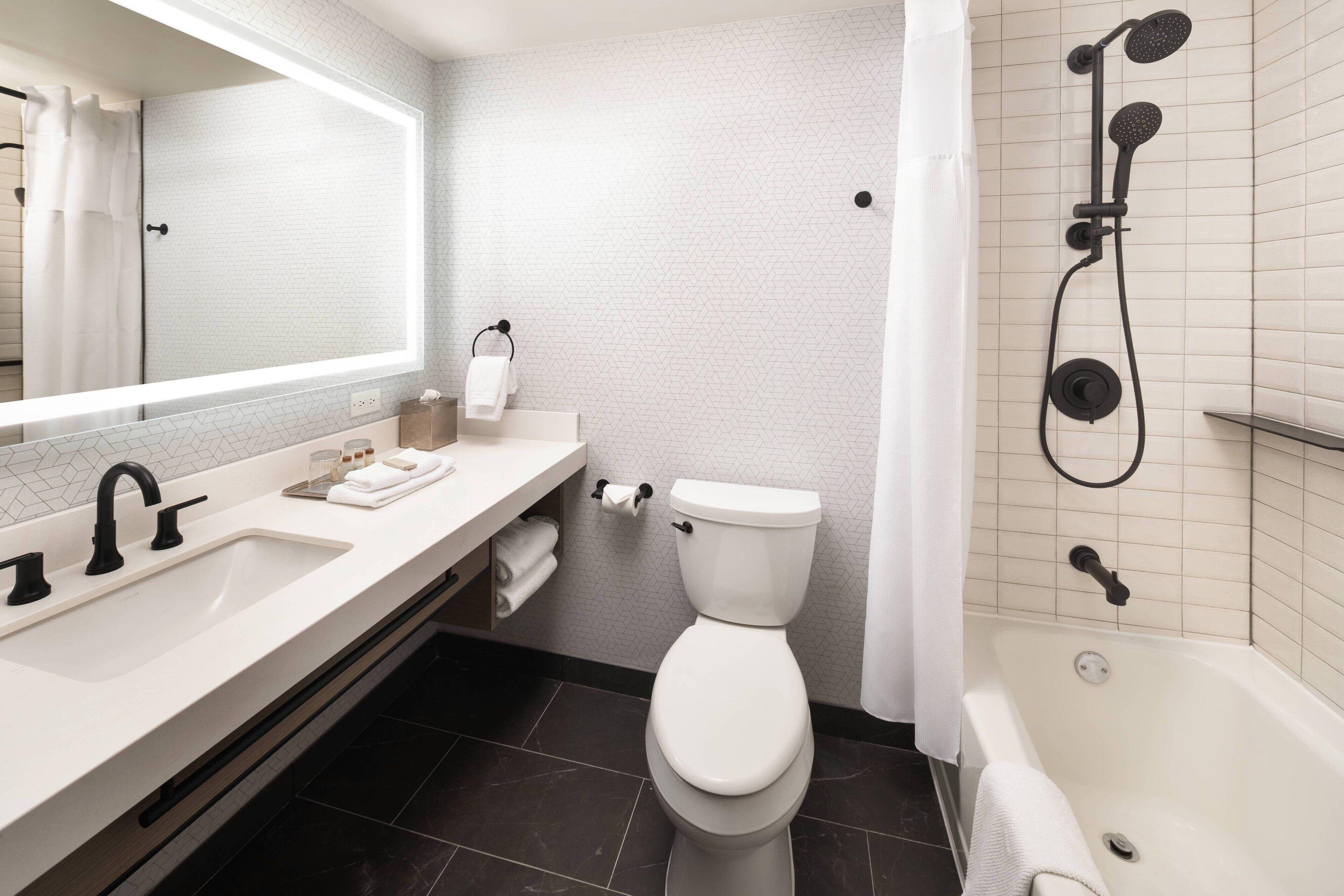 combined shower/bathtub, designer toiletries, hair dryer, bathrobes