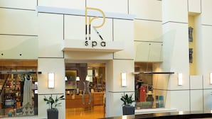 A spa with a reception area, potted plants, and a visible entrance.