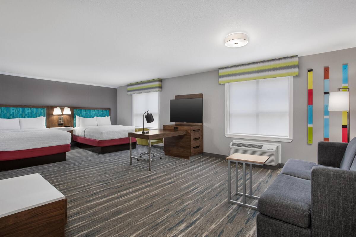 Suite, 2 Queen Beds | Living area | 37-inch flat-screen TV with cable channels, TV, video-game console