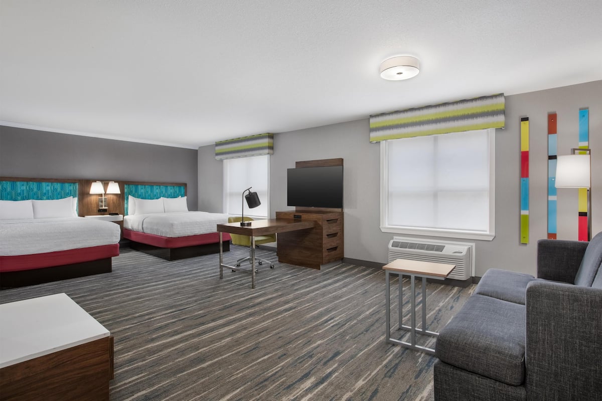 Suite, 2 Queen Beds | Living area | 37-inch flat-screen TV with cable channels, TV, video-game console