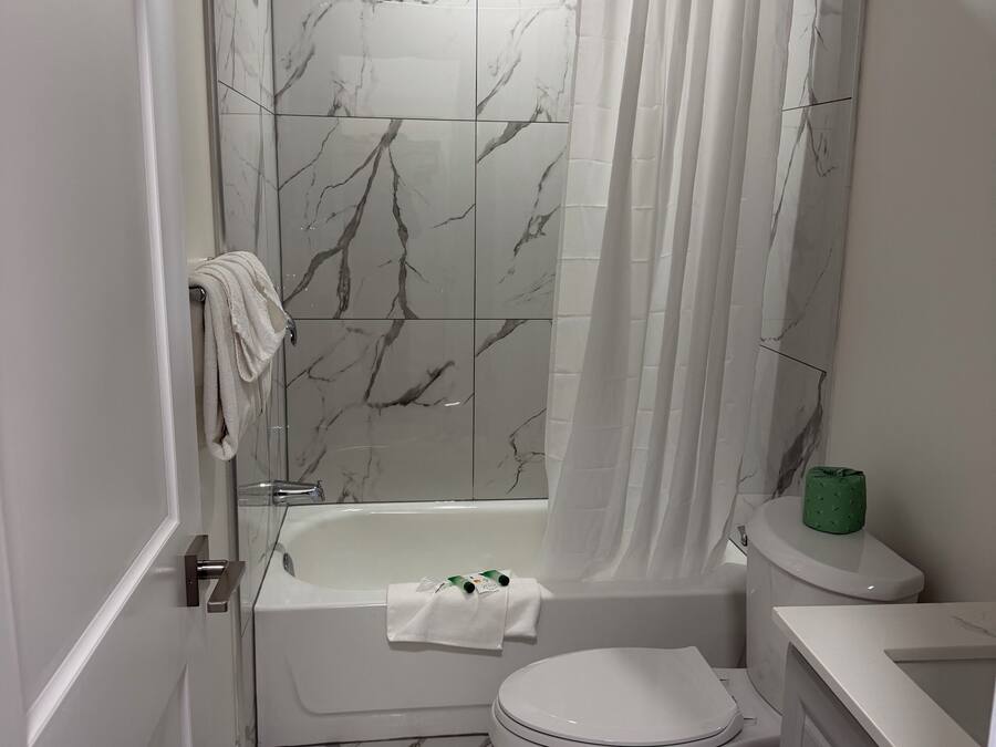 Room, 2 Double Beds | Bathroom | Combined shower/tub, free toiletries, hair dryer, towels