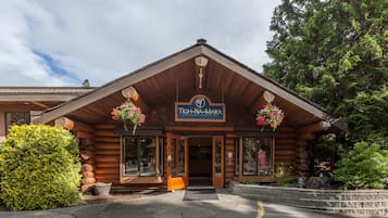 A log cabin-style building with a sign reading "TIGH-NA-MARA".