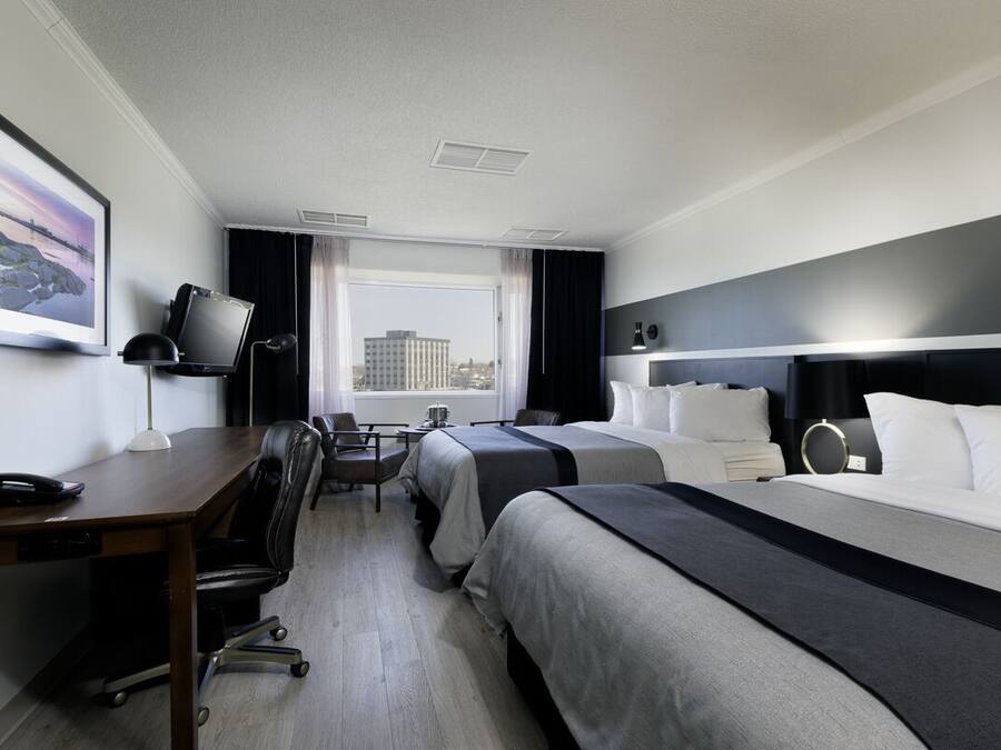 Premium bedding, desk, laptop workspace, blackout drapes