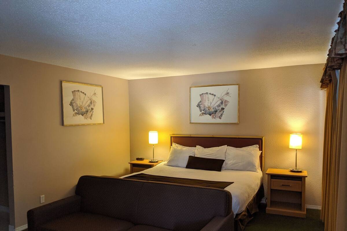 Premium bedding, desk, laptop workspace, blackout drapes