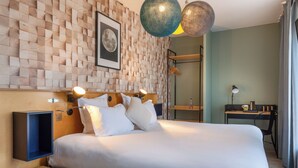A modern hotel room with a wooden wall panel design, a neatly made bed, a desk, and a large window with curtains. - Hôtel Bootcamp (Issy-les-Moulineaux)