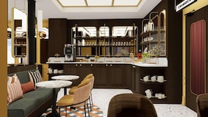 A modern bar area with a counter, seating, and a decorative mirror. - Grand Hotel De Turin (Paris)