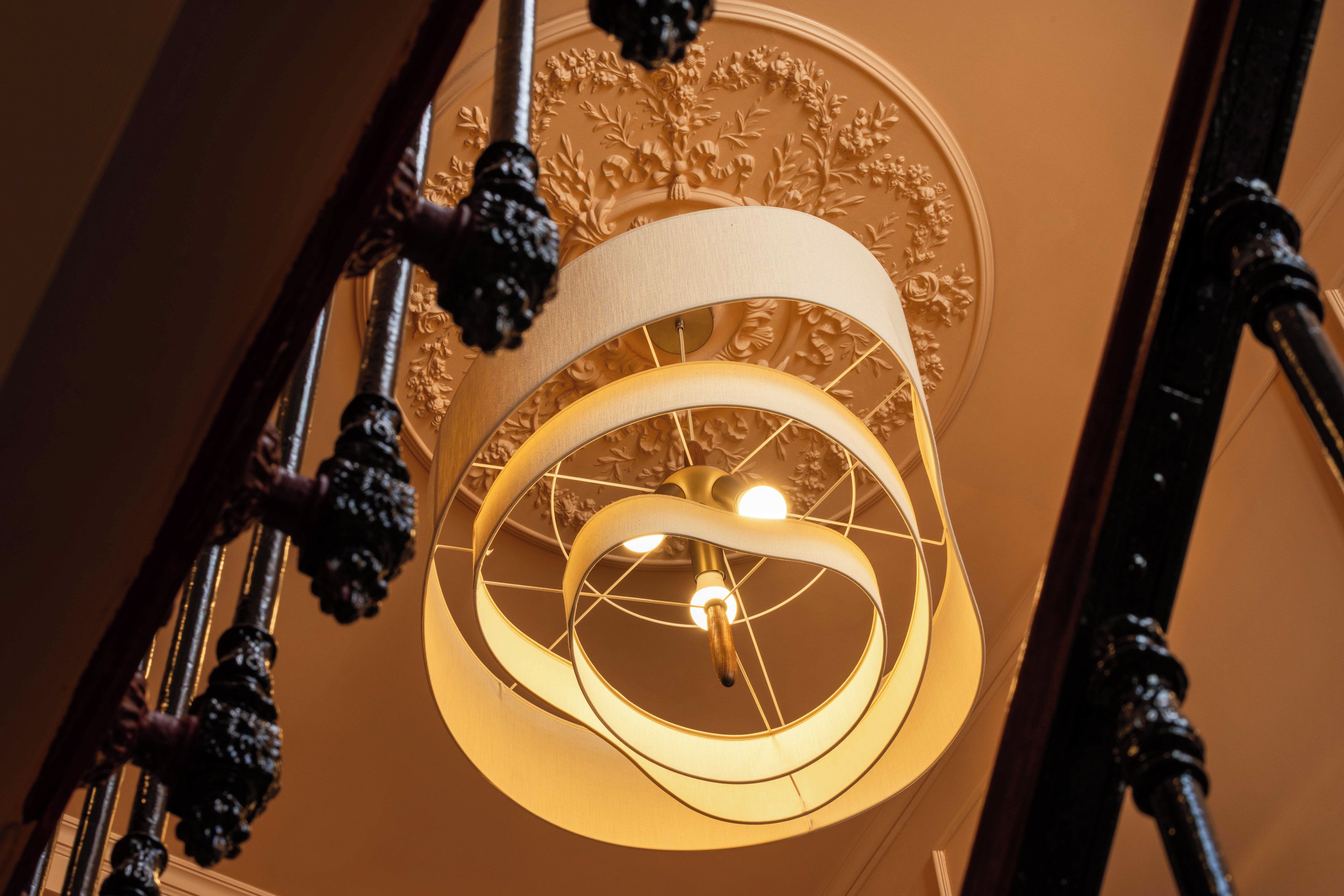 A chandelier with a circular design and a central light bulb.
