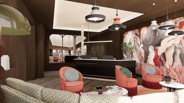 A modern interior with a reception desk, seating area, and pendant lighting. - Grand Hotel De Turin (Paris)
