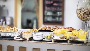 Een buffet met verschillende soorten eten en een wijnglas.