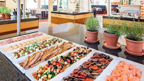 A buffet with various food options including meats, salads, and seafood. - NH München Ost Conference Center (Aschheim)