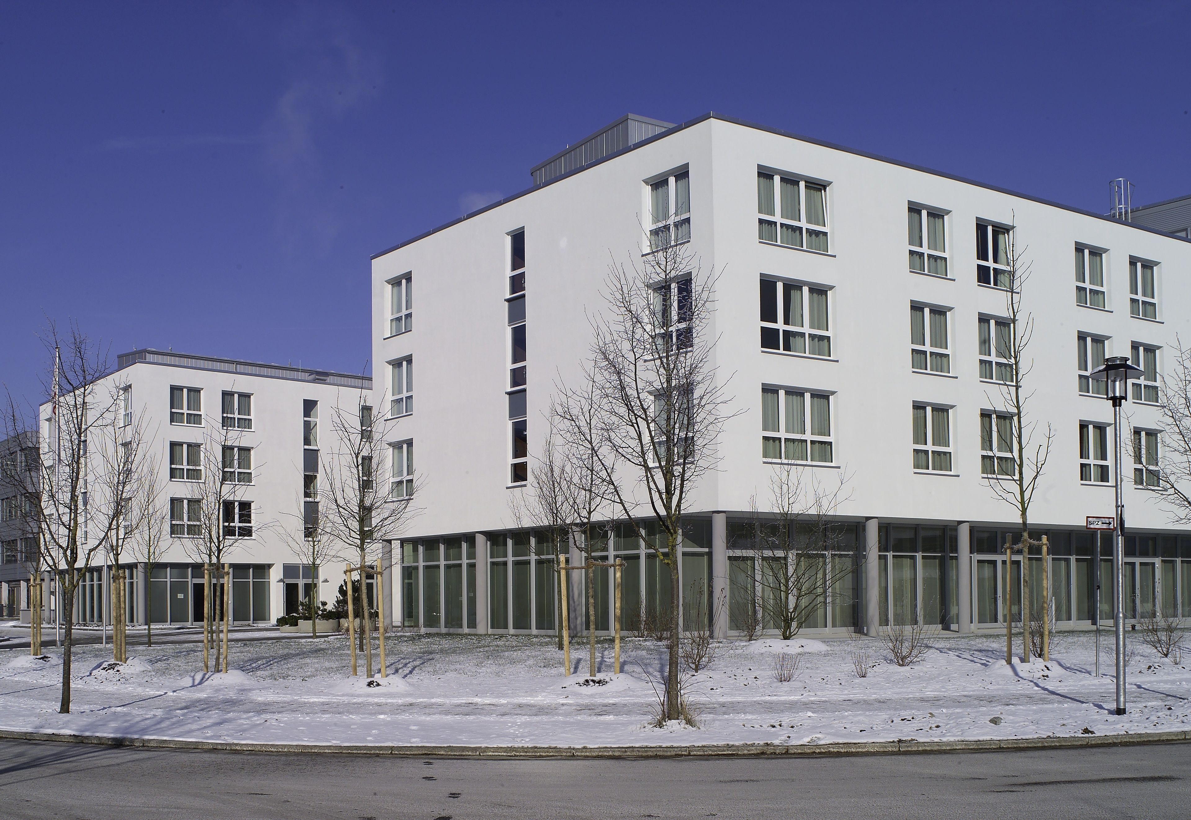 A modern building with multiple windows and a flat roof.