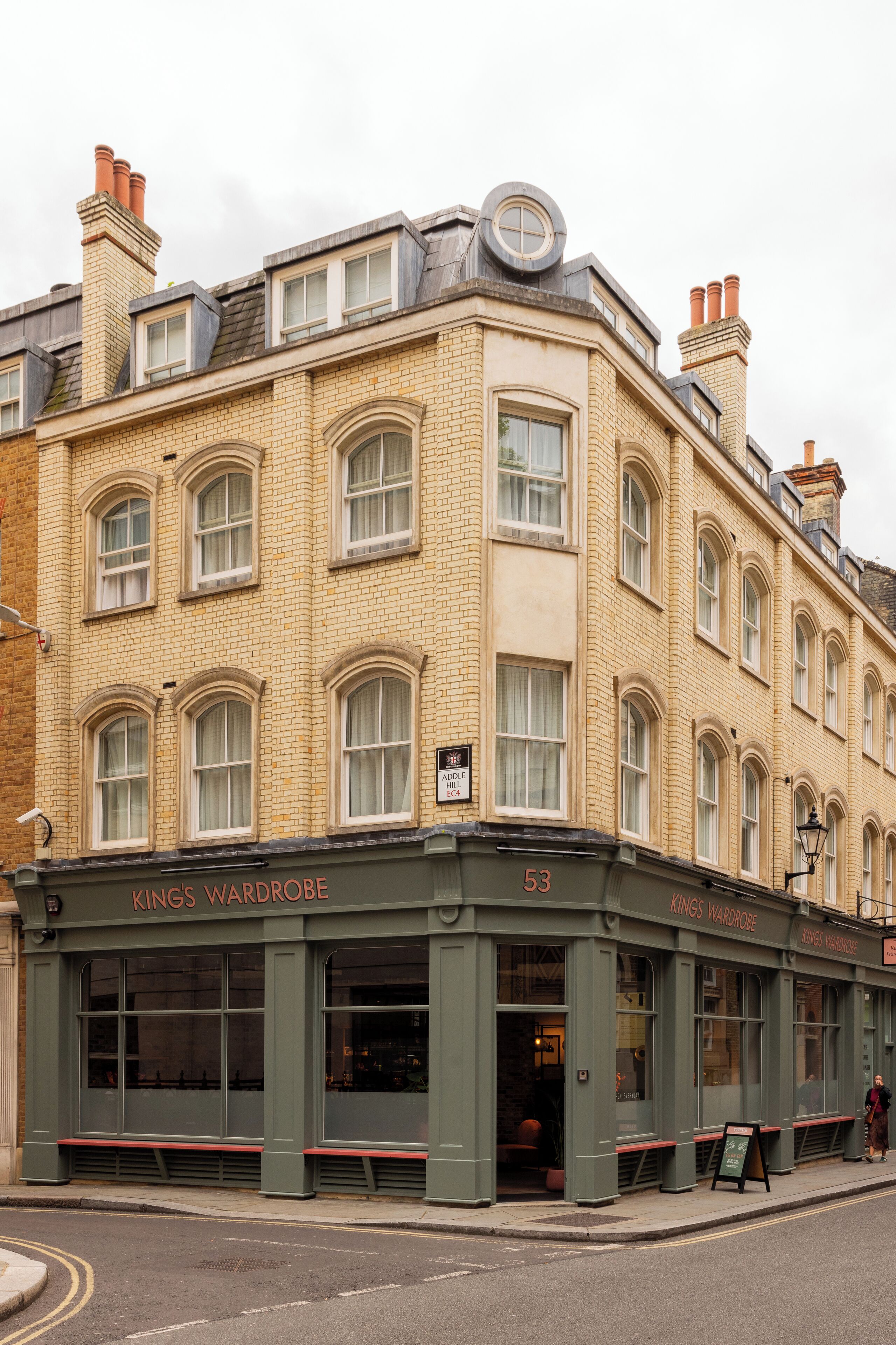 A corner building with a sign reading "Kings Wardrobe" and the number 53.