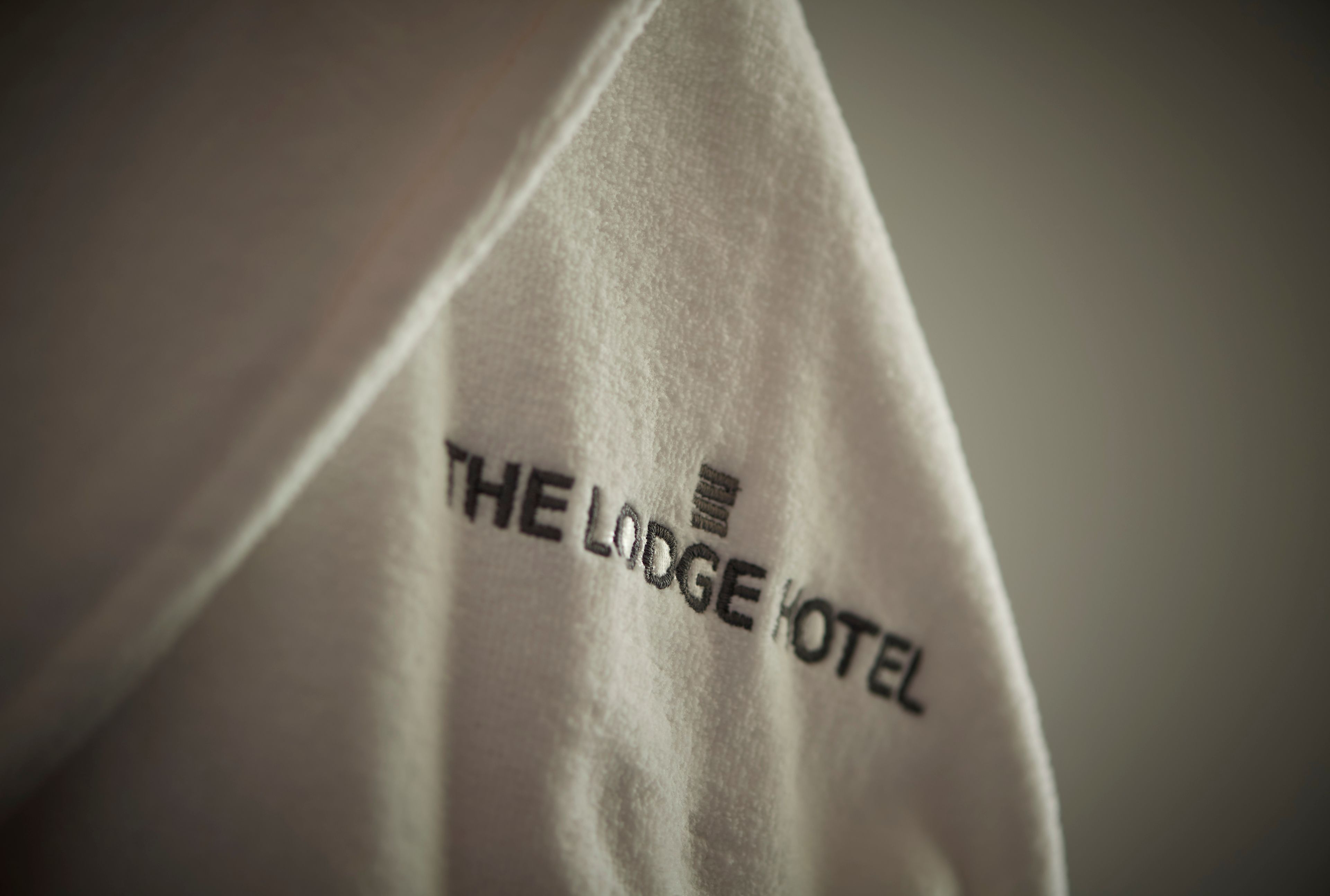 A close-up of a fabric with "THE LODGE HOTEL" printed on it.