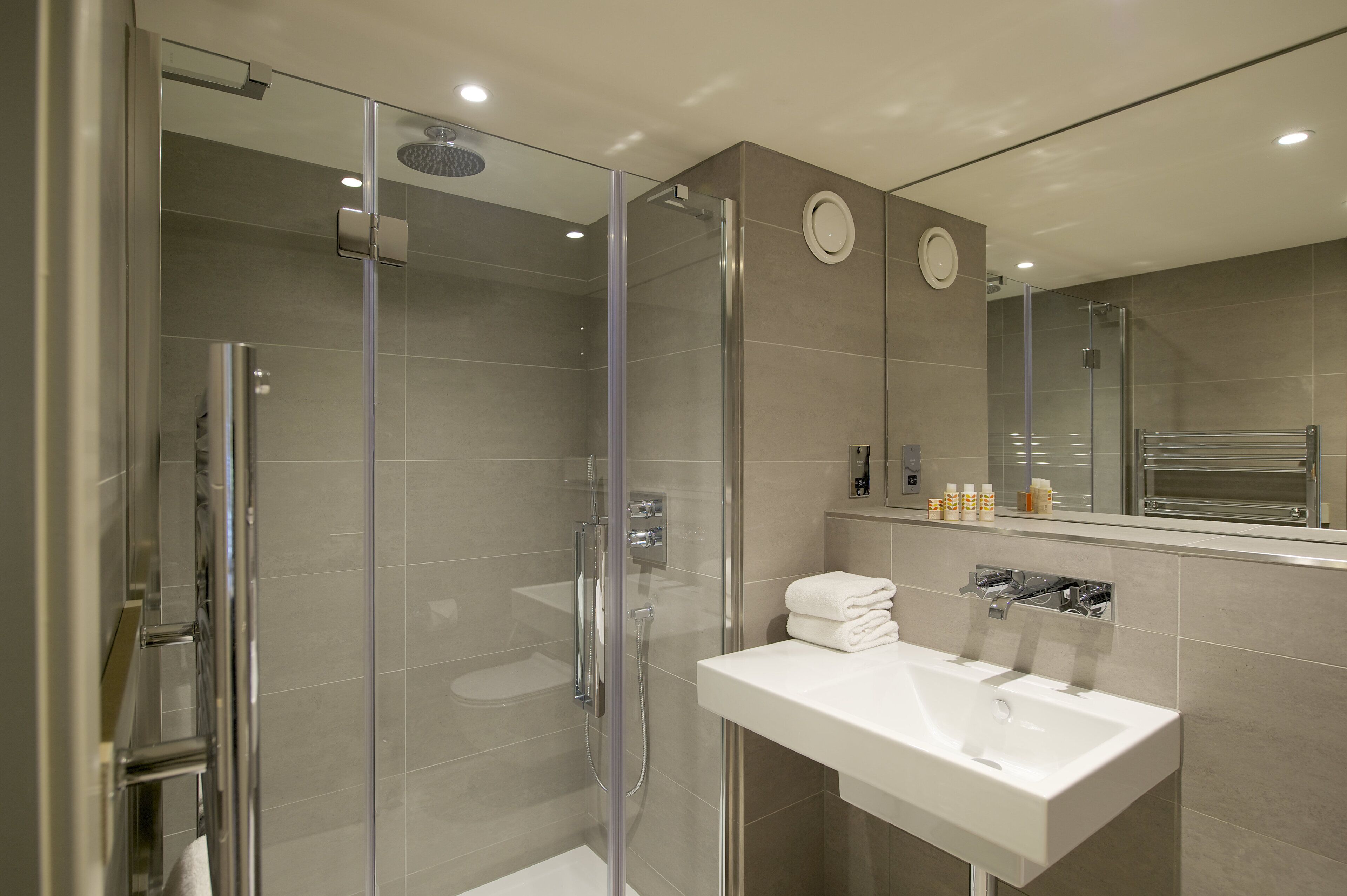 designer toiletries, hair dryer, soap, shampoo