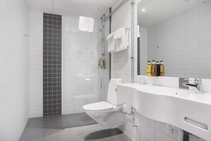 A modern bathroom with a shower, toilet, and sink. - Best Western Hotel River C (Karlstad)