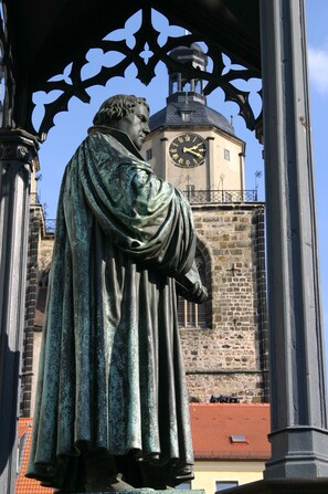 A statue of a historical figure with a clock tower in the background. - Best Western soibelmanns Lutherstadt Wittenberg (Lutherstadt Wittenberg)