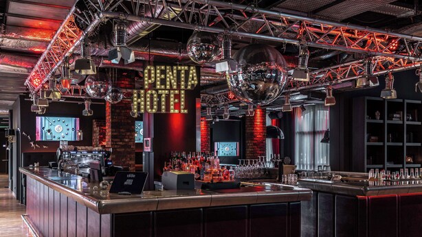 A bar area with a neon sign, disco balls, and a variety of bottles and glasses. - pentahotel Paris Charles de Gaulle Airport (Roissy-en-France)