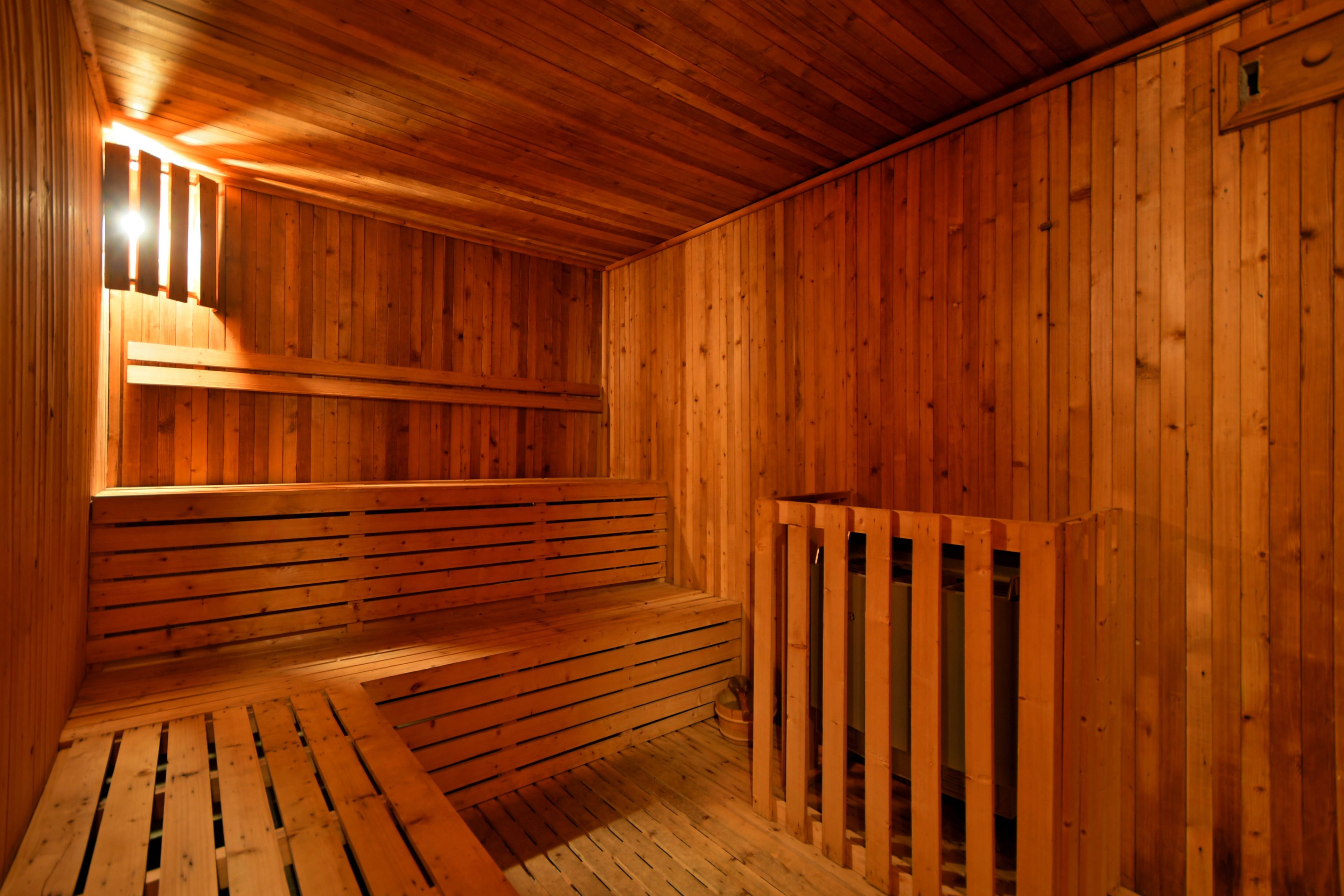A wooden sauna with benches and a bench seat.