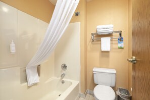 A bathroom with a bathtub, toilet, and a shower curtain. - Days Inn by Wyndham Battlefield Rd/Hwy 65 (Springfield)