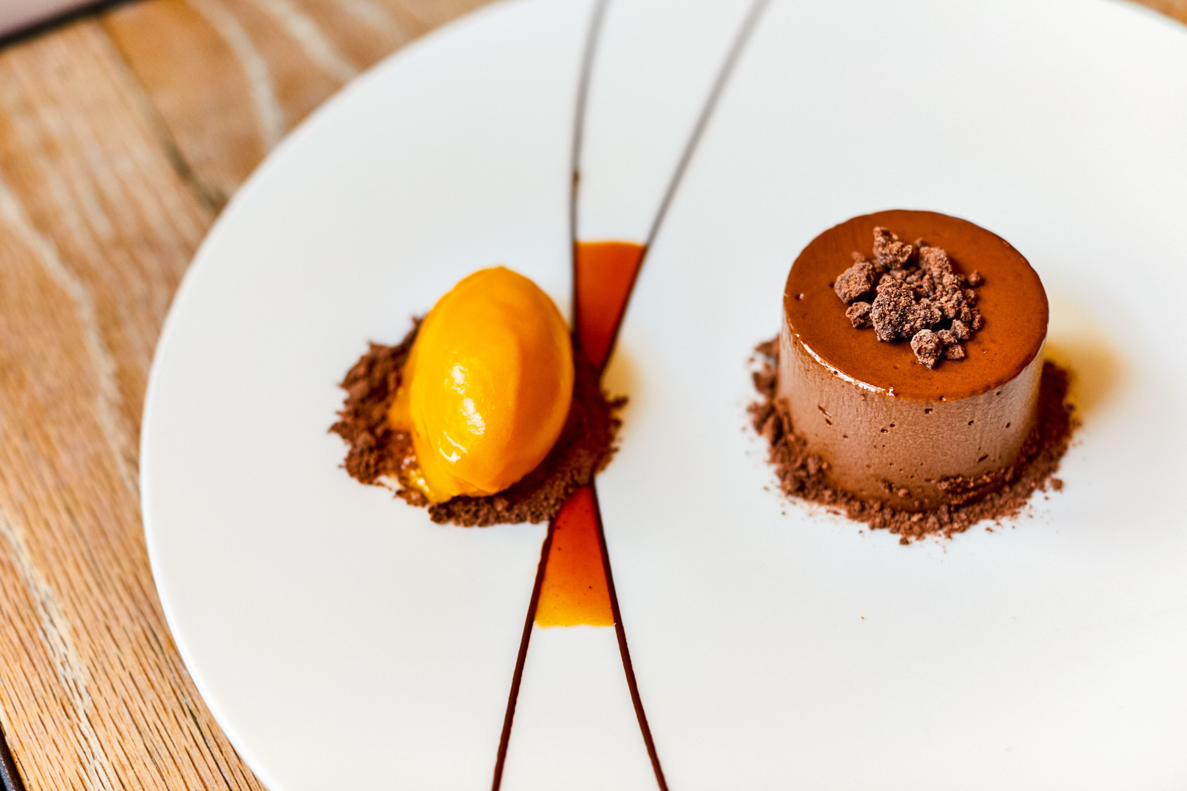 A dessert on a white plate with a caramel sauce drizzle.