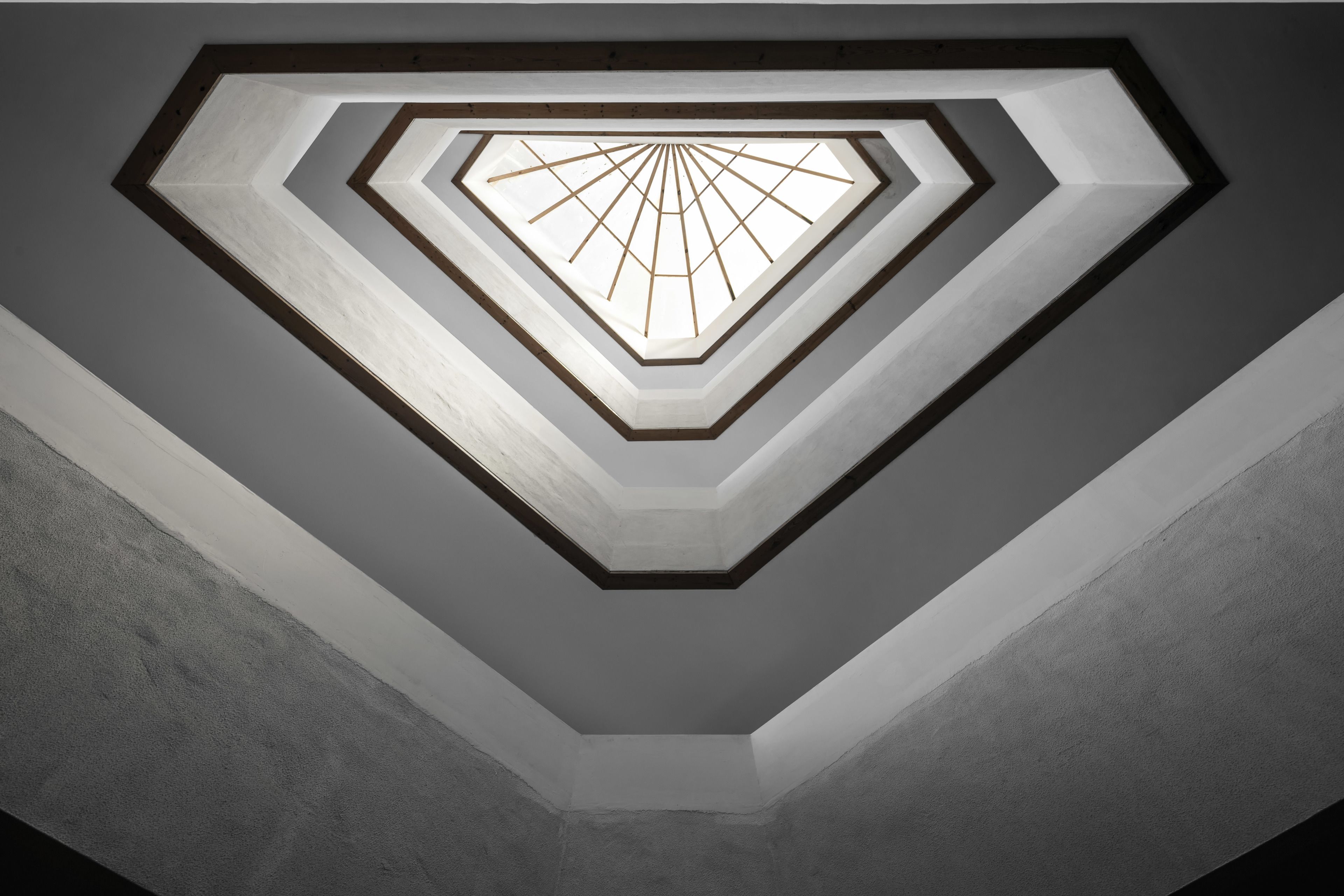 A geometric ceiling design with a central light fixture.