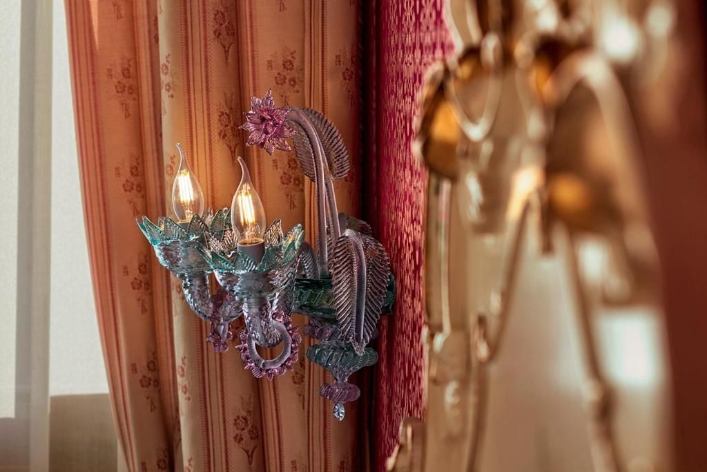 A wall-mounted light fixture with multiple candles.
