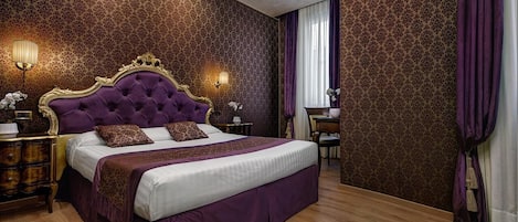 Un dormitorio con una cama grande, un cabecero ornamentado y un papel tapiz estampado.