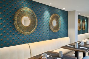 Relax in a stylish space with a large mirror, comfortable sofa, and dining area for two.