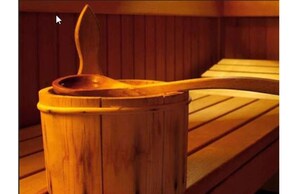 Relax on a curved wooden sauna bench in a warm, natural setting.