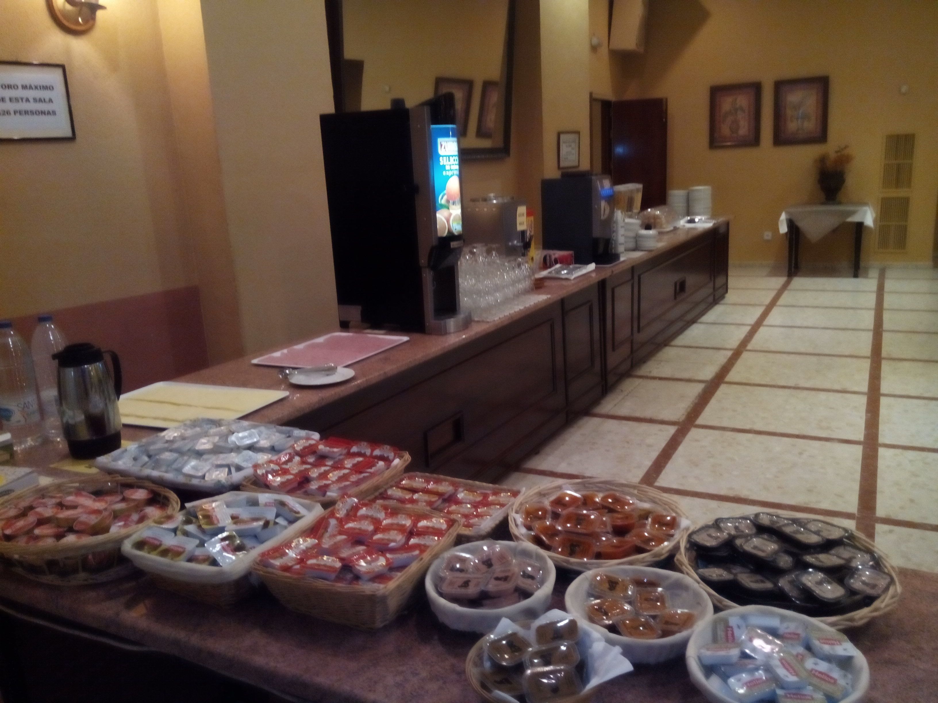 A buffet area with various food items and a coffee station.