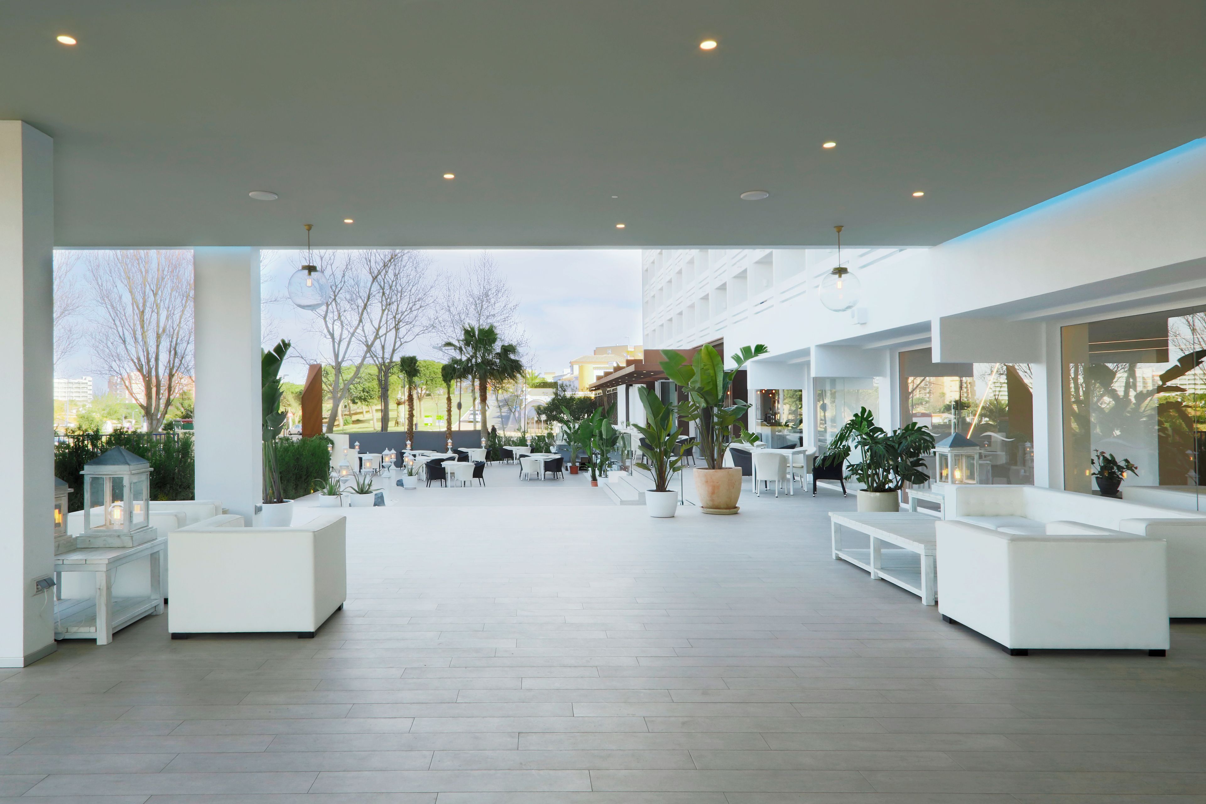 A spacious outdoor area with modern seating arrangements and potted plants.