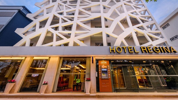 A modern hotel with a geometric facade and a visible ATM machine. - Hotel Regina (Ourem)