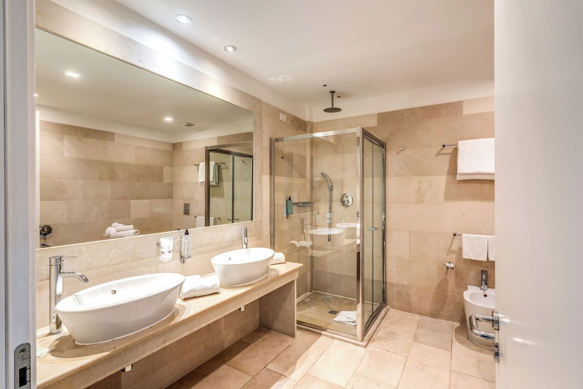 family suite | bathroom | shower, rainfall showerhead, hair dryer, bidet