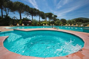 Seasonal outdoor pool, open 10:00 AM to 7:00 PM, pool umbrellas